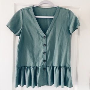 Green peplum style shirt.